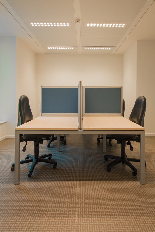 Office space with desk and chairs with LED lighting